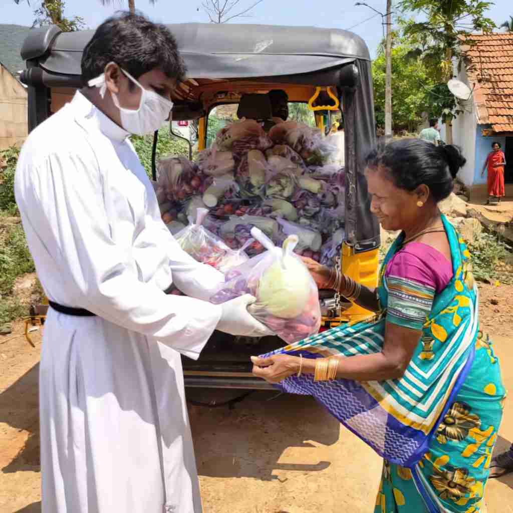 GFA World worker giving relief package to woman
