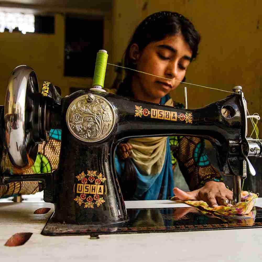 Woman sewing clothes with a sewing machine