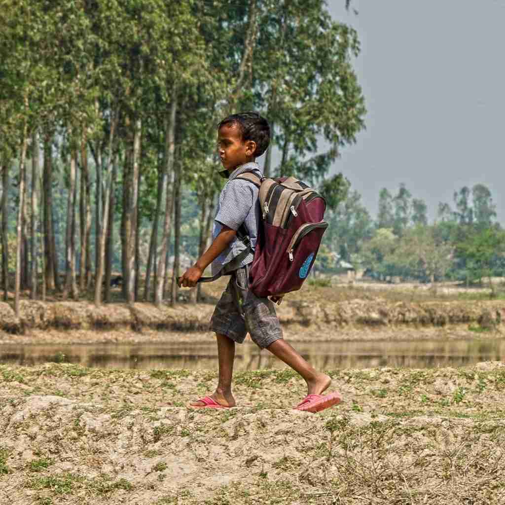 Young boy walks long distances to go to school