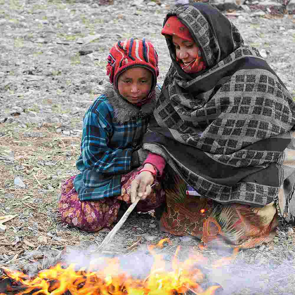 Many families in Asia, even in colder regions, have no indoor heating—just a little fire to keep themselves warm. A blanket or a winter clothing packet can help a family survive in the terrible winters.