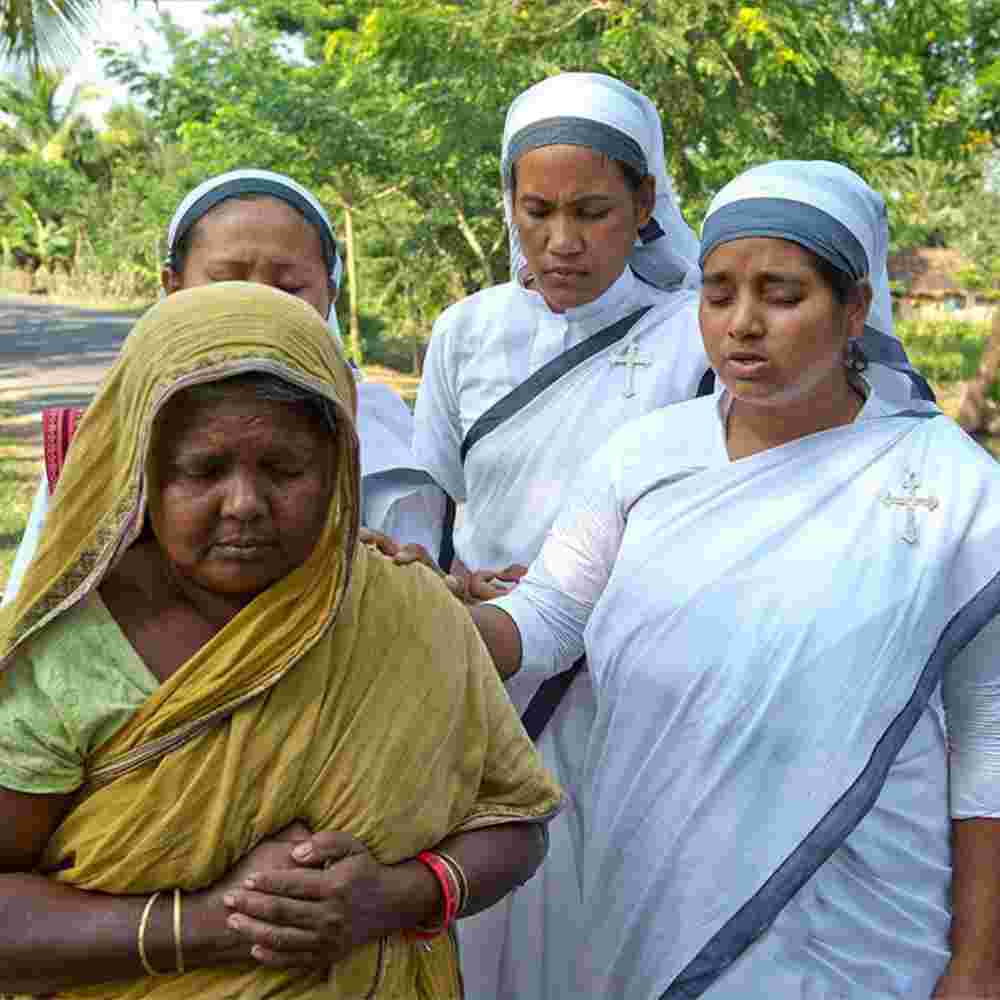 Sisters of Compassion, GFA World's women missionaries, pray for a widow