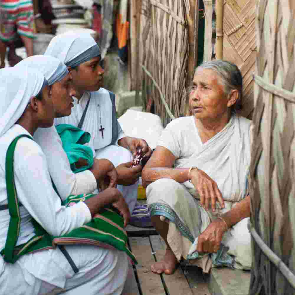 Sisters of Compassion ministering to a woman in need, amid poverty and illnesses in her family