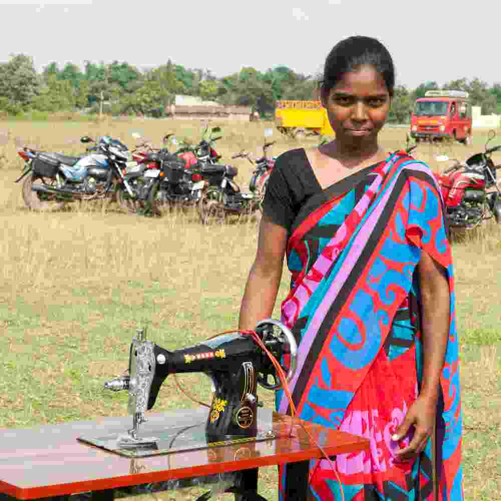 Woman in Asia received an income generating gift of a sewing machine that would help lift up her family from poverty