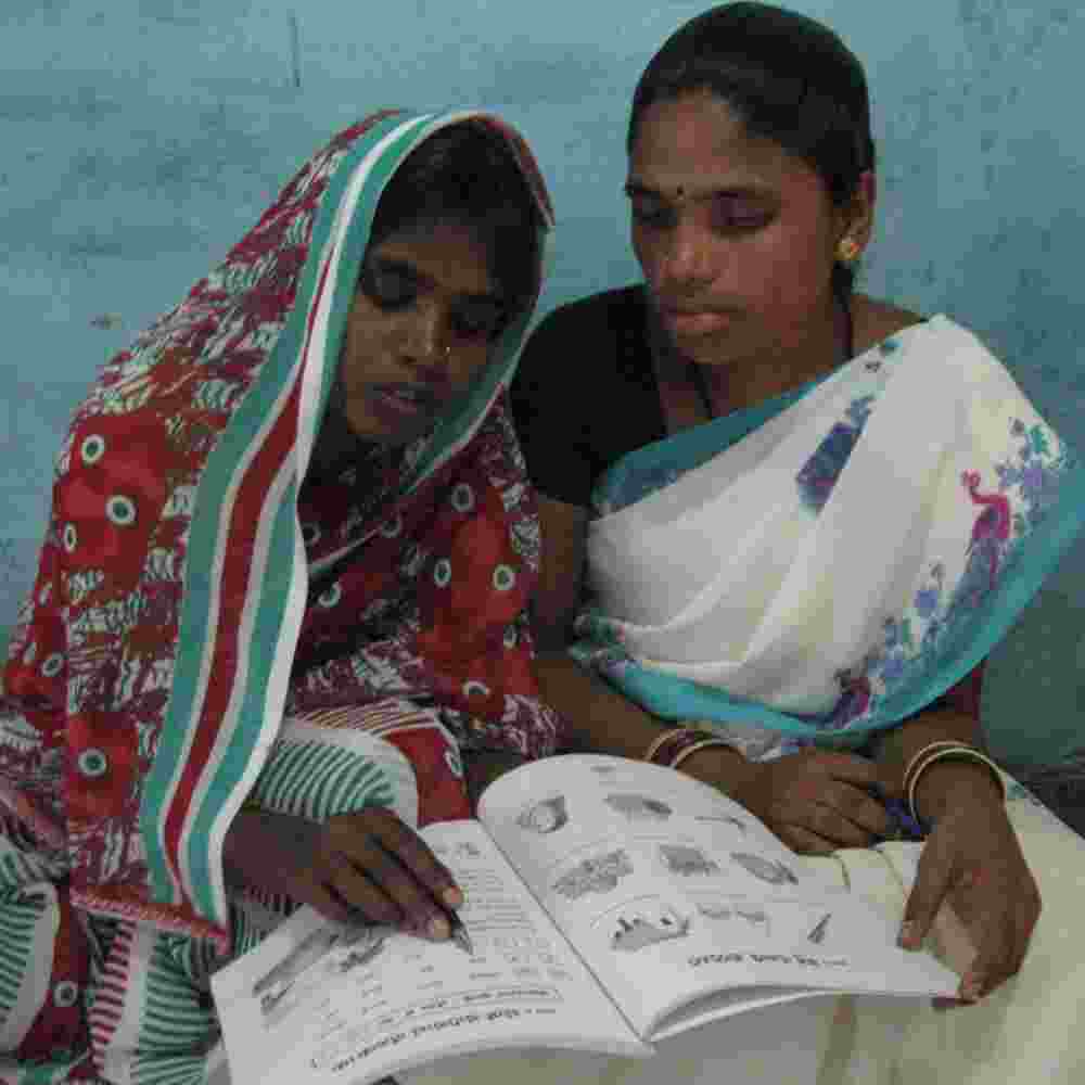Woman learning through GFA World adult literacy class