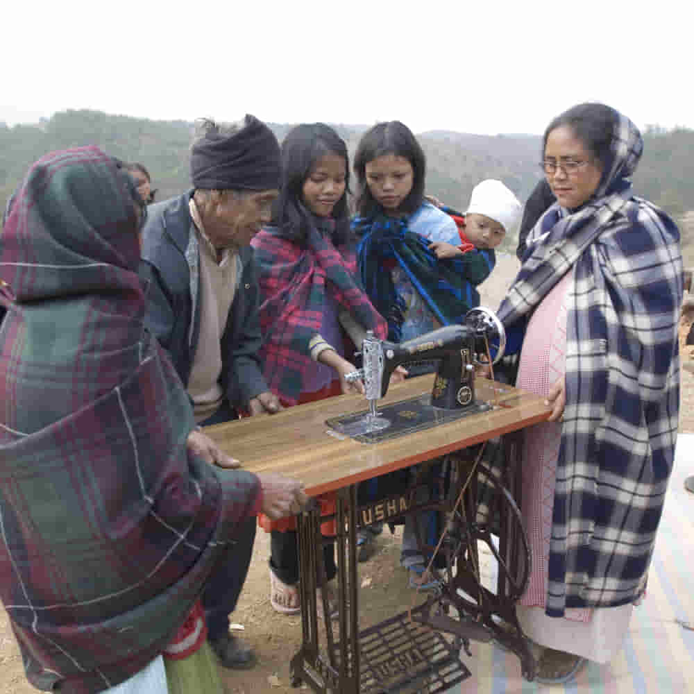 A family received an income generating gift of a sewing machine through GFA World child sponsorship program Bridge of Hope