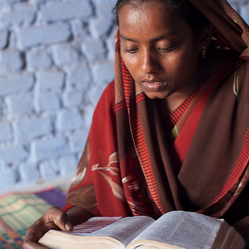 Woman reads her Bible thanks to GFA World adult literacy class