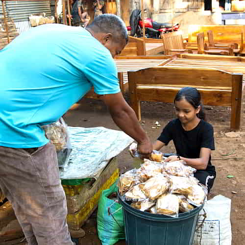 Young girl in child labor in the local market
