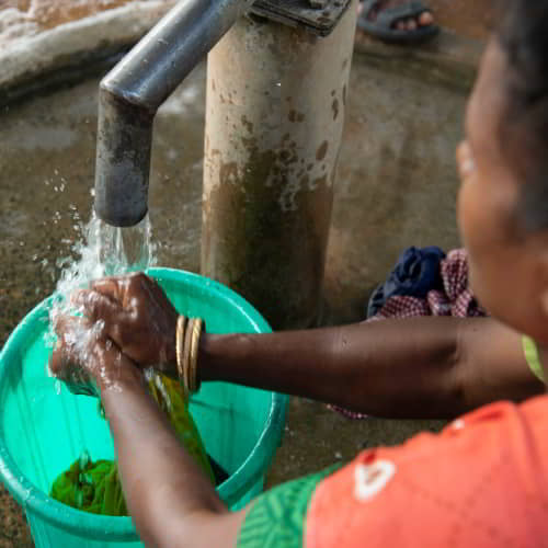 Woman washing using clean water from GFA World Jesus Wells