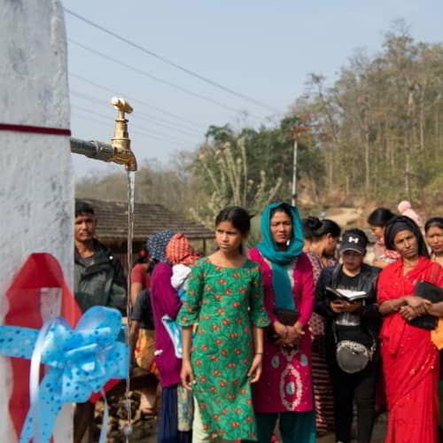 A village community in Nepal enjoys clean water through GFA World water well drilling