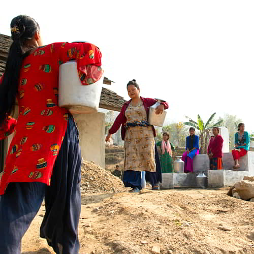 Group of women drawing clean water from GFA World provided Jesus Wells in Nepal