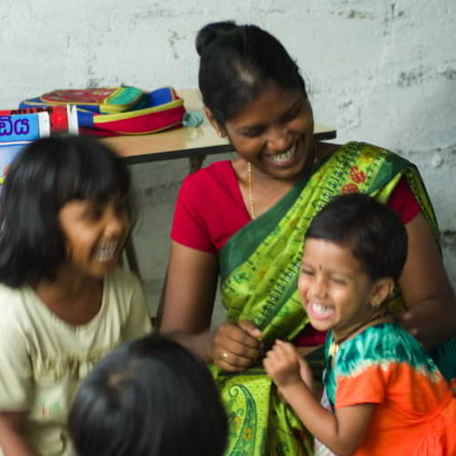 Woman missionary teaching girls in GFA World child sponsorship program