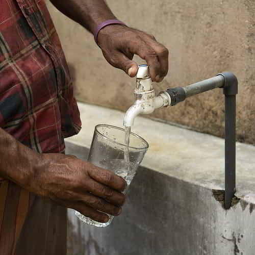 Filling up a glass of clean water through GFA World Jesus Wells