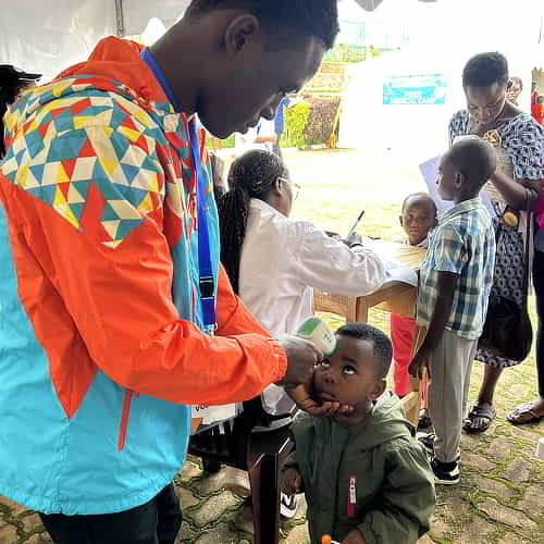 GFA World medical camp missionary attends to child patient in Rwanda