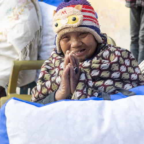 Woman thankful for the gift of warm blankets through GFA World