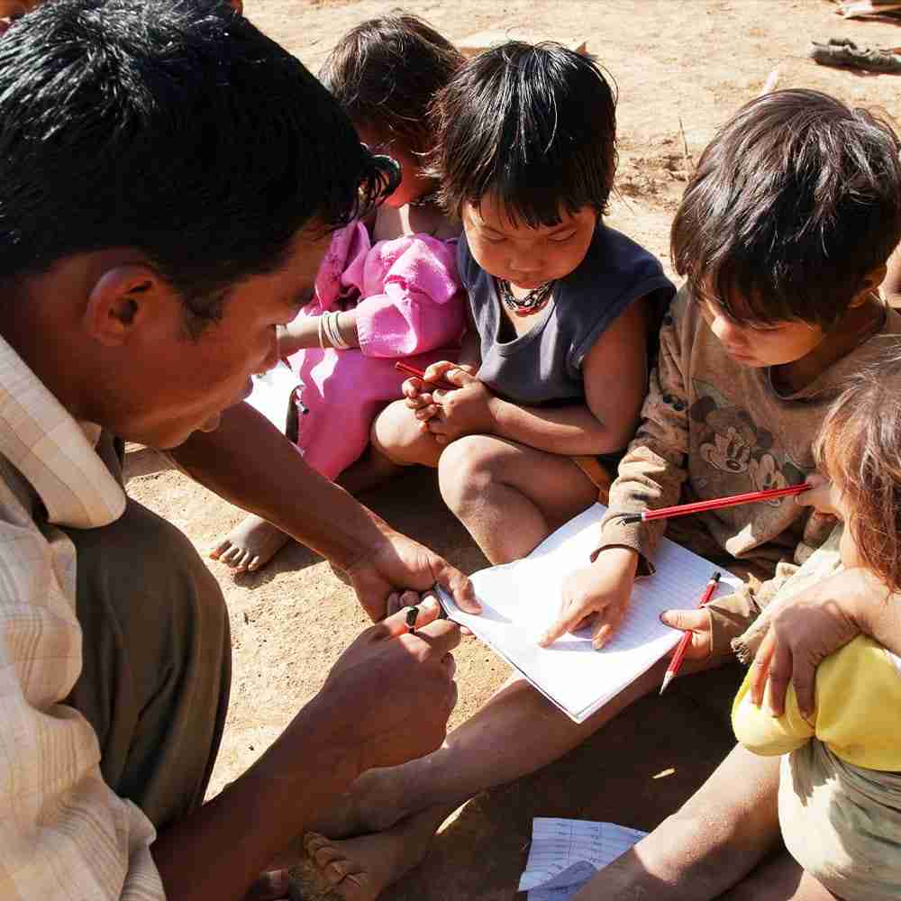 GFA pastor is teaching these little children how to read and write, and showing the love of God in the process.