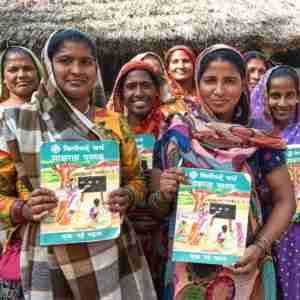 Group of women holding up their free literacy book