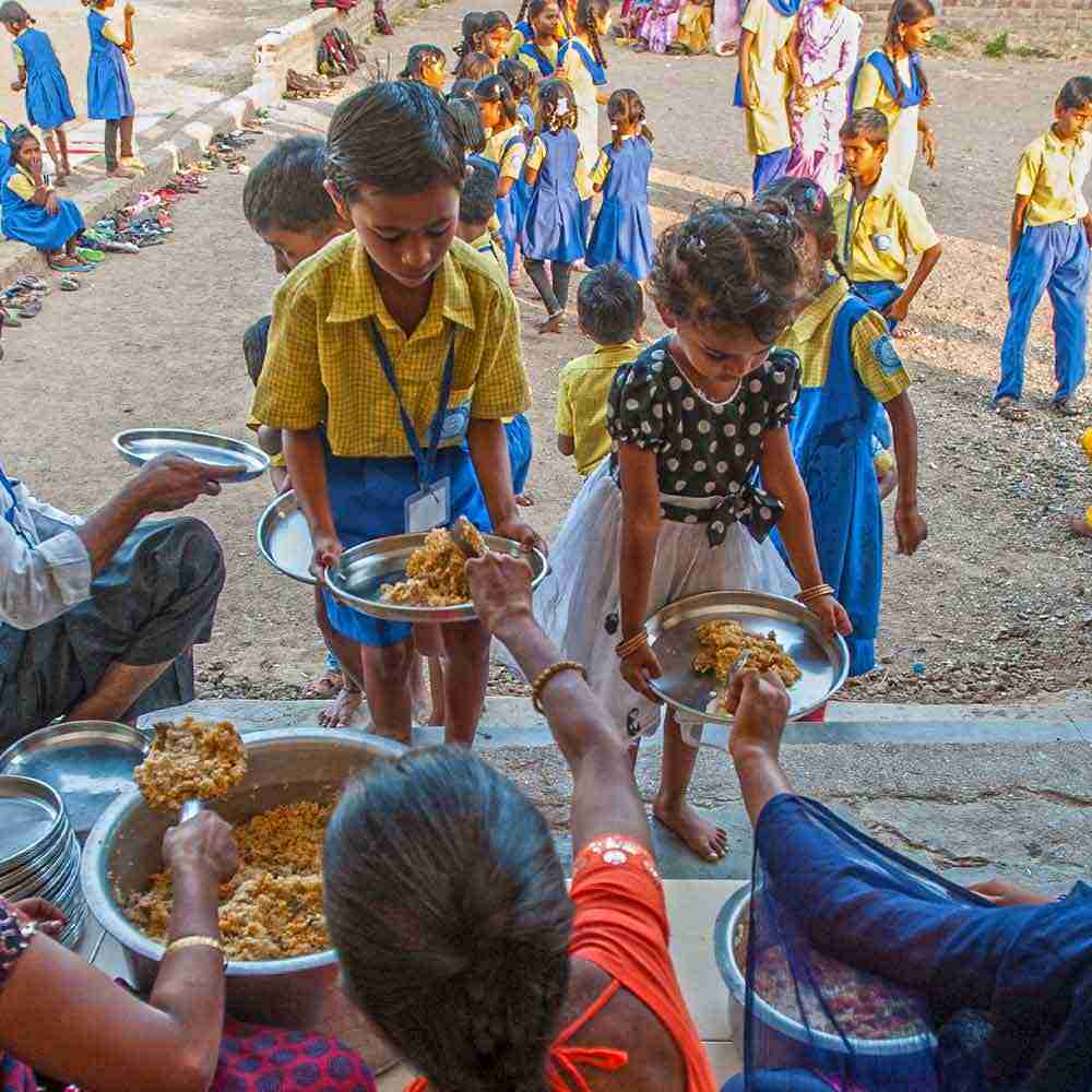 Bridge of Hope staff serve food to children