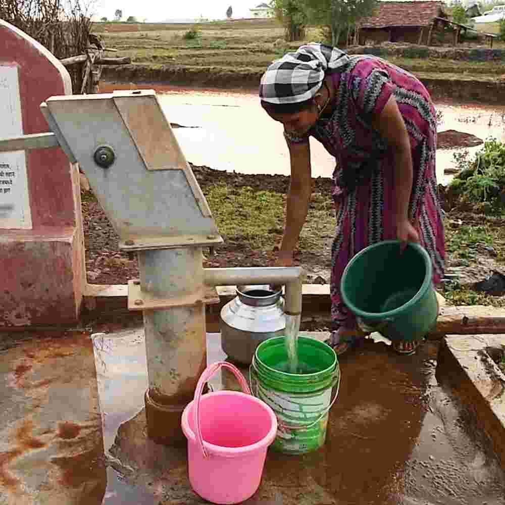 A woman from Vimal's village acquiring clean water from GFA World Jesus Wells