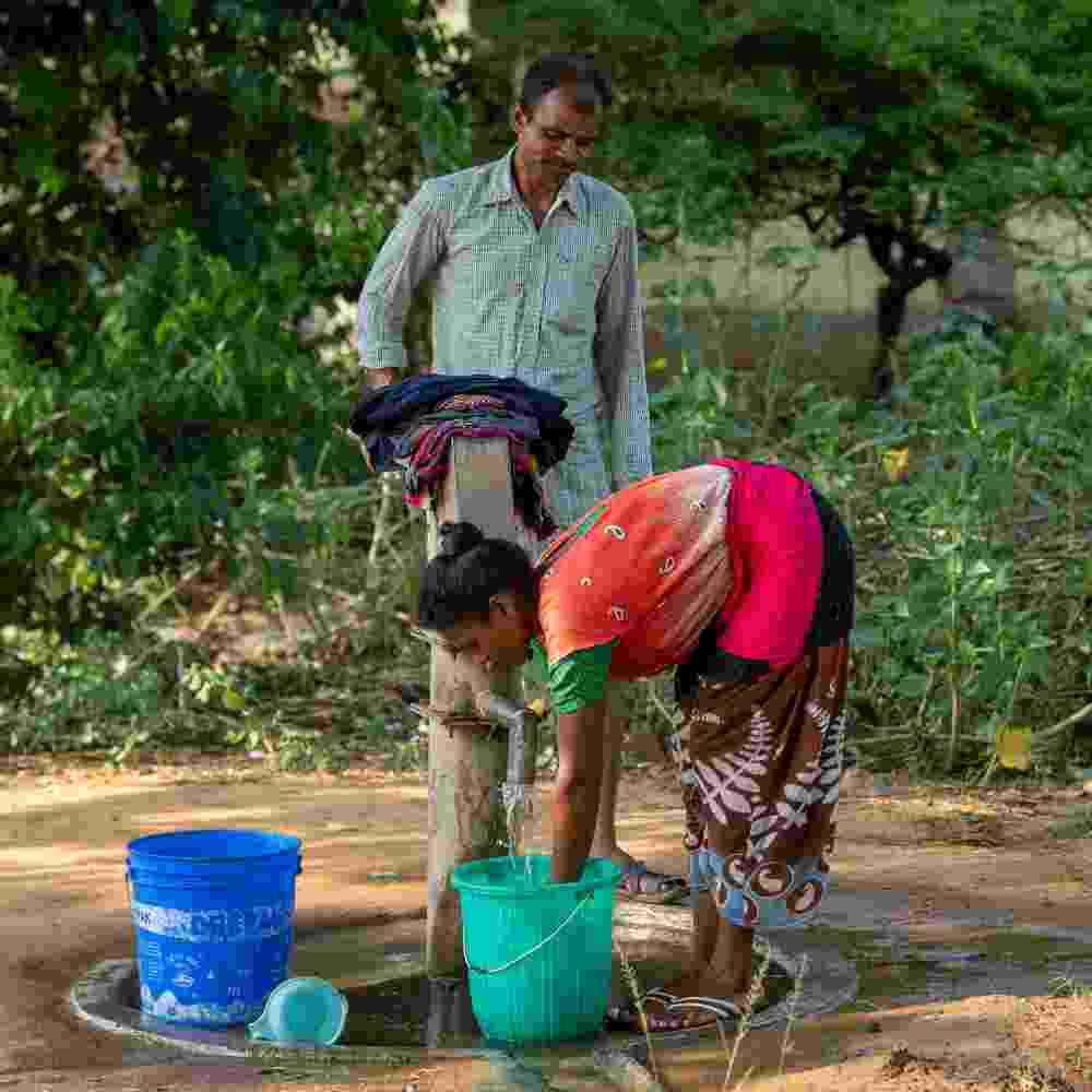 Man and wife use clean water from GFA World Jesus Wells
