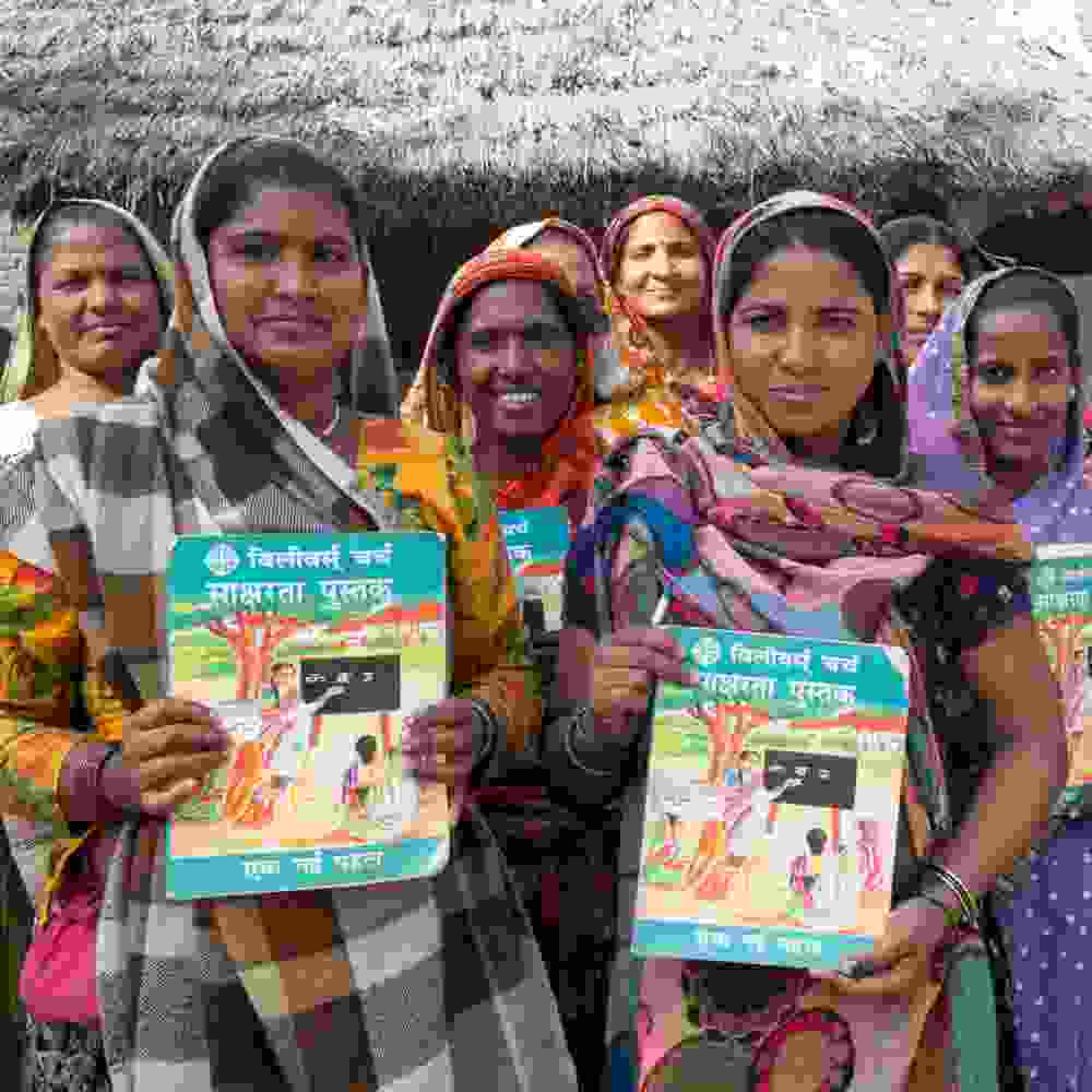 Women with their workbooks from GFA World adult literacy class