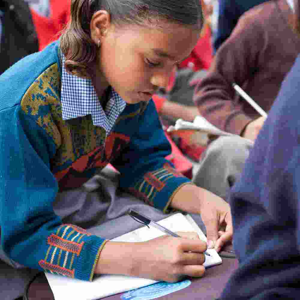Young girl studying in Bridge of Hope center