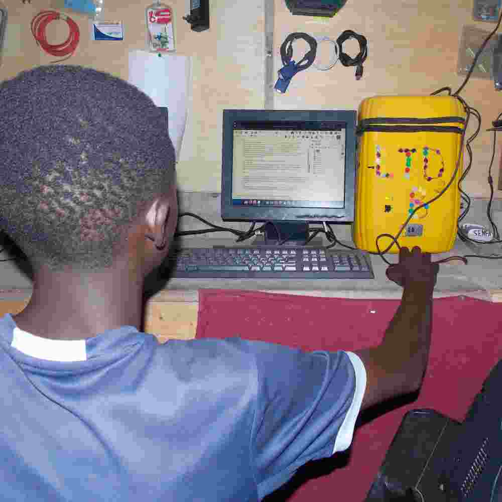 Young boy being computer skills training