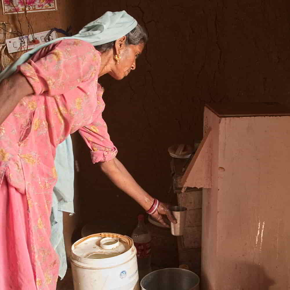 Woman acquires clean water through GFA World BioSand Water Filter