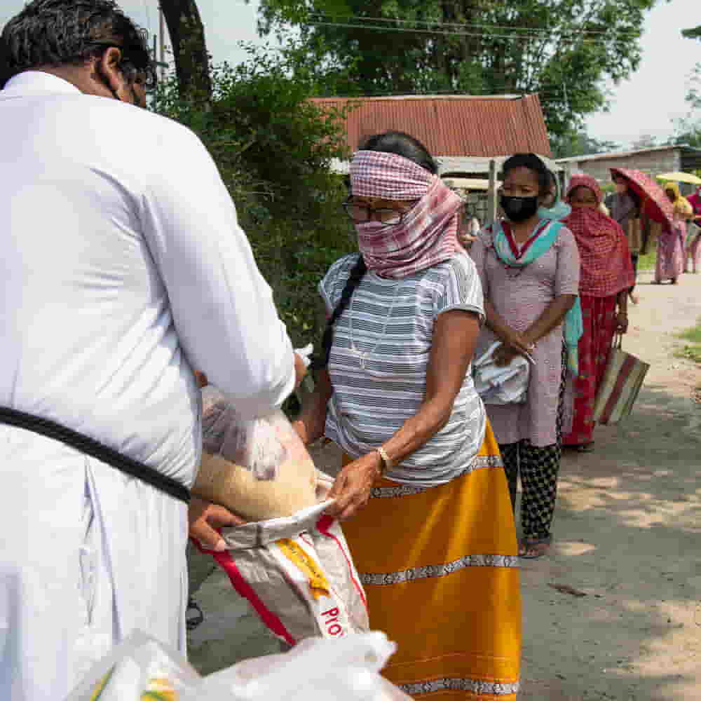 Village community receiving relief goods from GFA World amid COVID 19