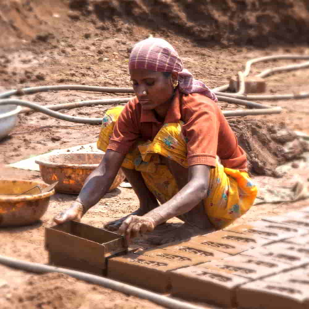 Woman in poverty making bricks