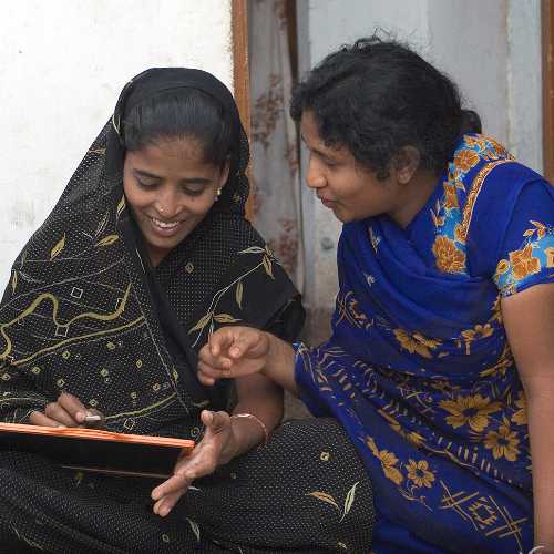 Woman receives an education through GFA World adult literacy class