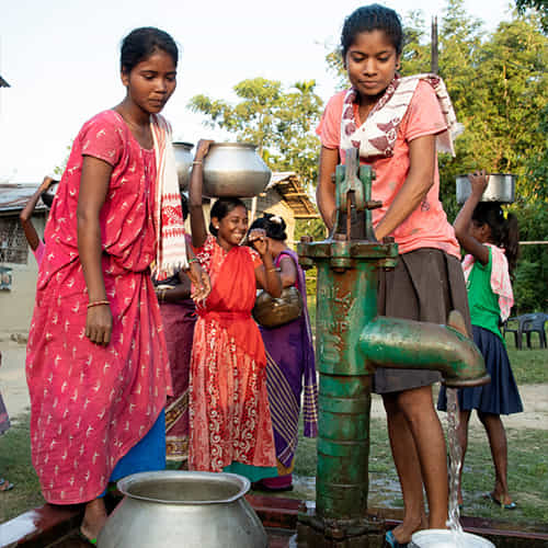 Women and children draw clean water through GFA World Jesus Well