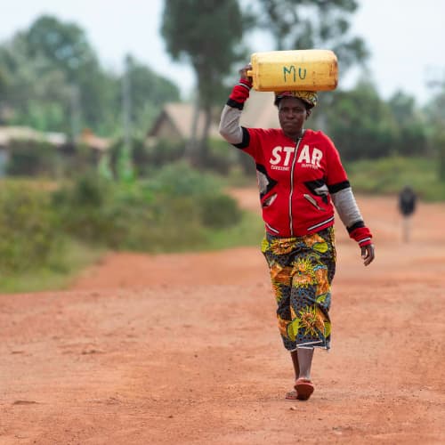 Women and children walk long distances to acquire water in Rwanda, Africa