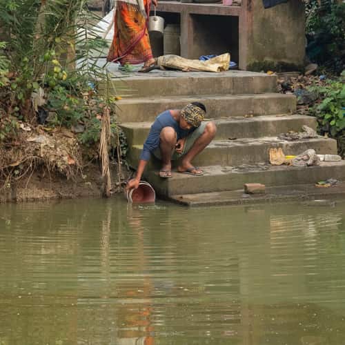 Collecting contaminated water in South Asia