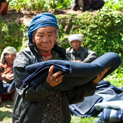 GFA World (Gospel for Asia) disaster relief volunteers distribute blankets to earthquake victims in Nepal