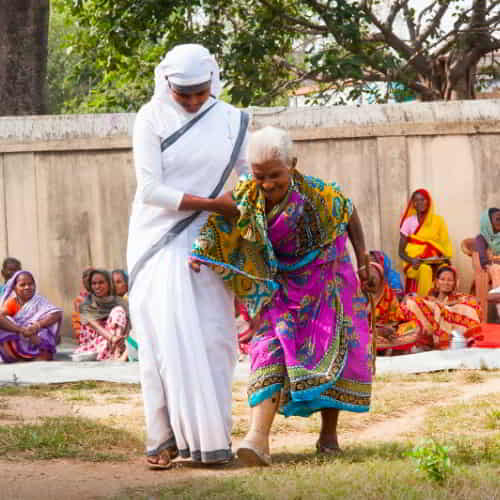 GFA World (Gospel for Asia) woman missionary showing God's love to an elderly leprosy patient