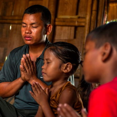 Family in South Asia in prayer