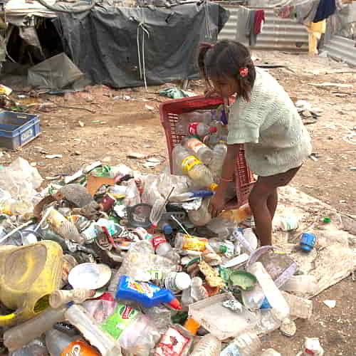 Young girl living in the slums of South Asia enduring the effects of poverty on child development