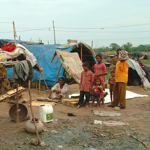A family in the slums of South Asia experiencing the effects of poverty on society
