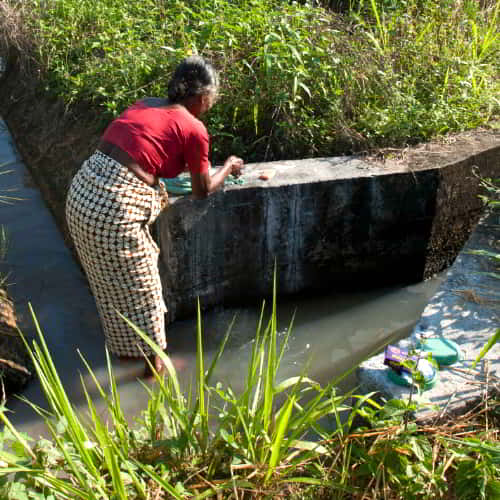 Woman from Sri Lanka washing using contaminated water