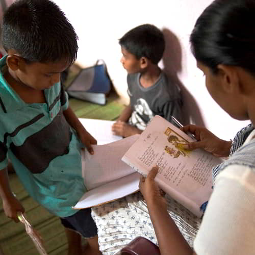 Young boy receiving instruction from GFA World Child Sponsorship Program staff in Sri Lanka