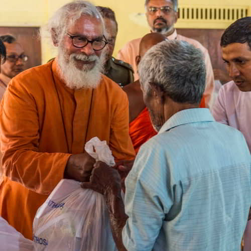 GFA World founder, KP Yohannan, helps distribute relief supplies in the aftermath of severe flooding in Sri Lanka