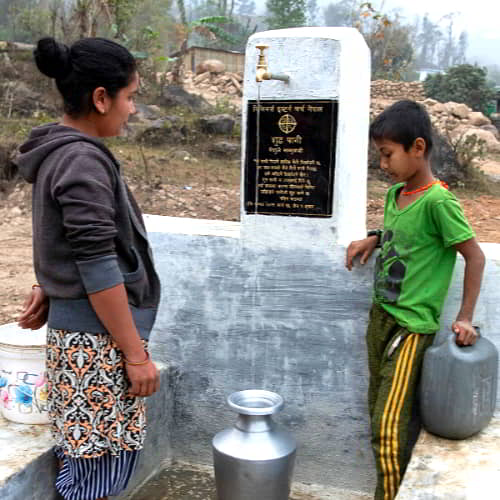 Mother and son from Nepal collecting clean water through GFA World Jesus Wells