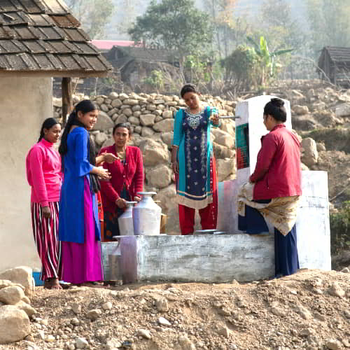 A village community enjoys clean water through GFA World Jesus Well drilling