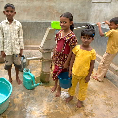 Children collecting clean water through GFA World Jesus Wells in Sri Lanka