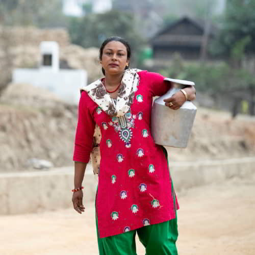 Woman from Nepal carrying a jar of water