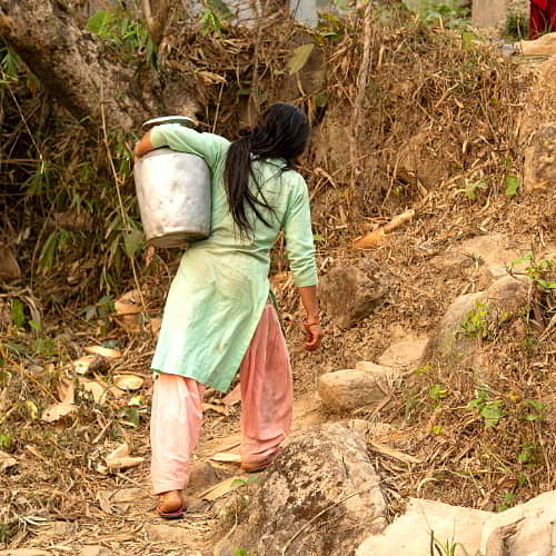 Women and children walk long distances to acquire water that is often from unsafe open water sources