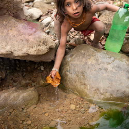 Young boy from Nepal collecting contaminated