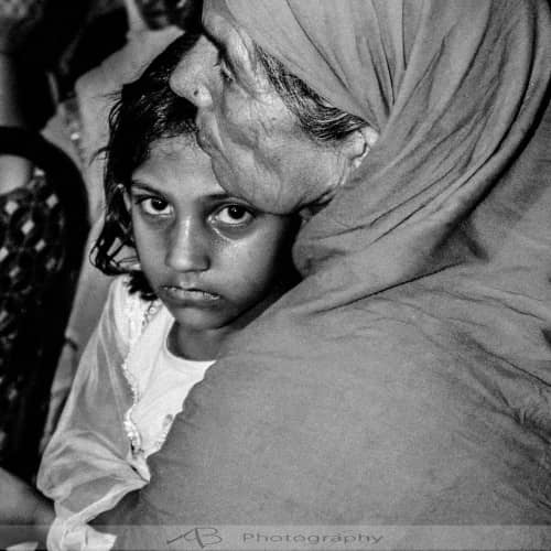 Elderly woman and young girl in poverty