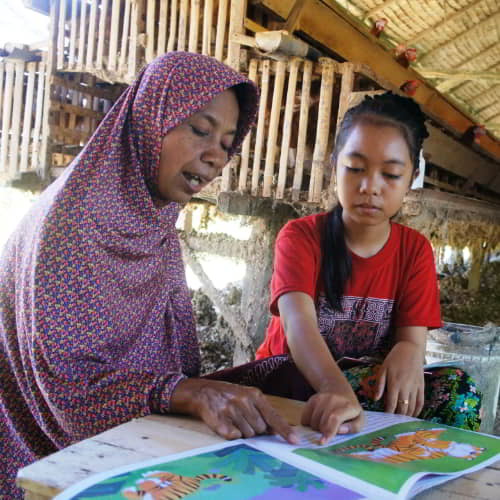 Woman receiving literacy education in Indonesia