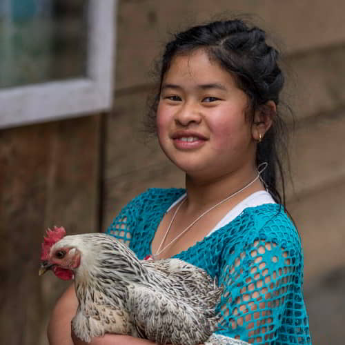 This girl's family received an income generating gift of a chicken from GFA World